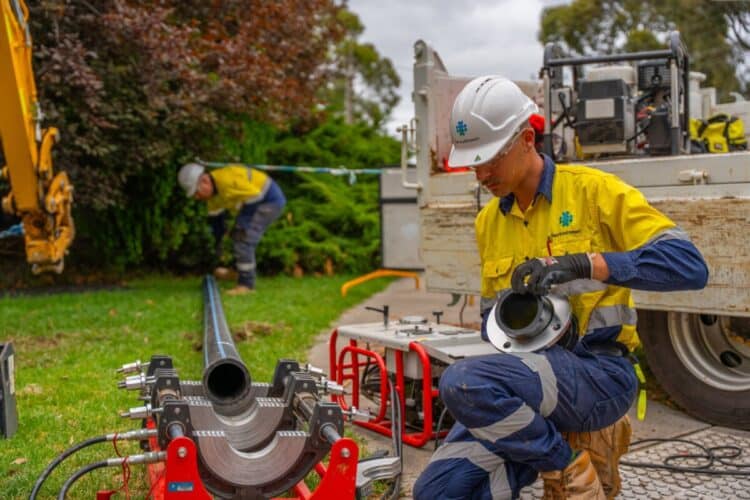 Service Stream technicians install a new pipe.