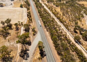 A roadtrain runs parallel to the Wather pipeline in Western Australia’s mineral rich Pilbara region.